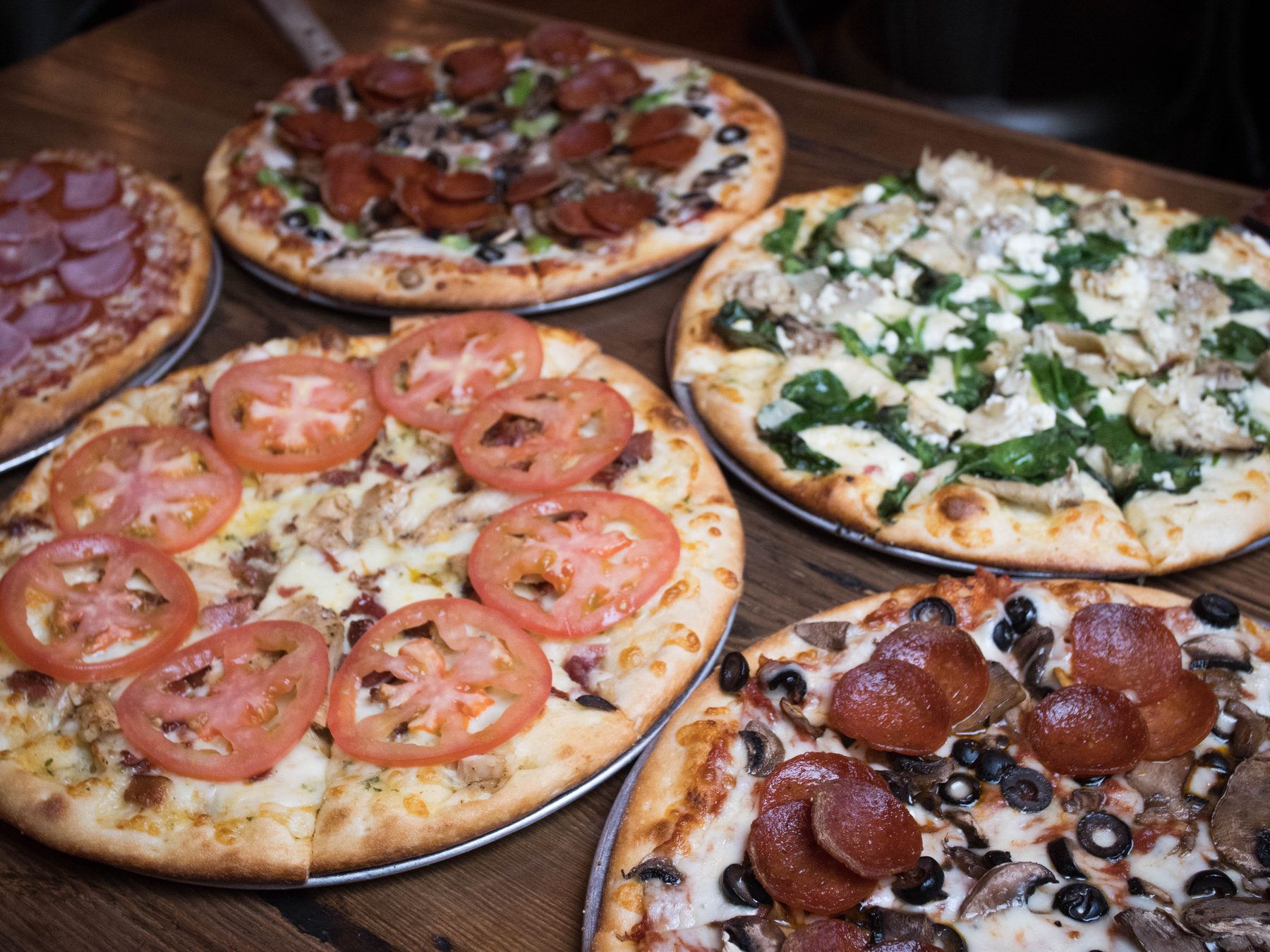 A spread of finished Litzas pizzas on the table